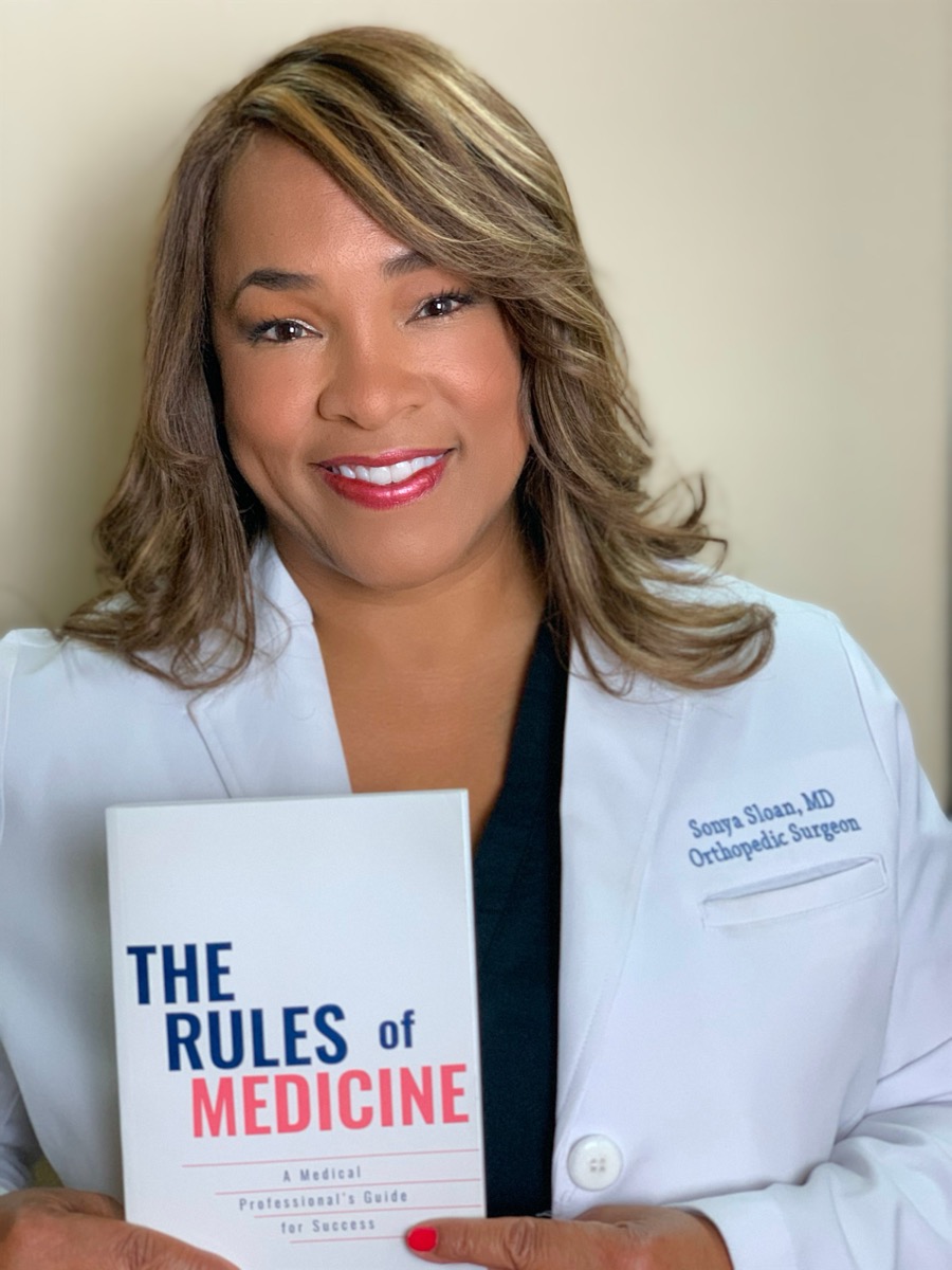 Dr. Sonya Sloan holding The Rules of Medicine