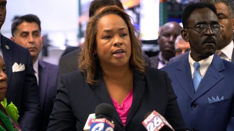 Woman speaks at a podium.