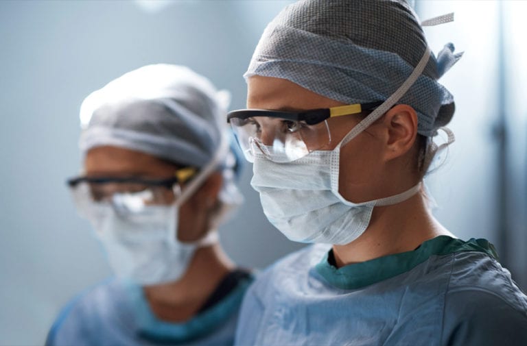 surgeons wearing masks and glasses